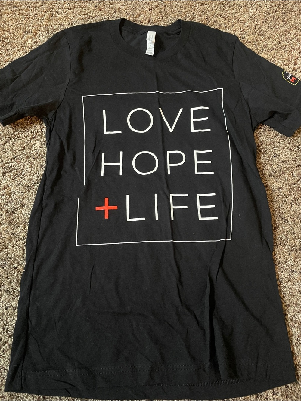 Bella Canvas Black Tee with White Text and Red Cross